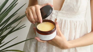 Woman holding a jar of body scrub